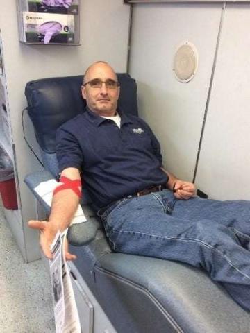 Photo of a Decker Electric team member donating blood in the American Red Cross bus