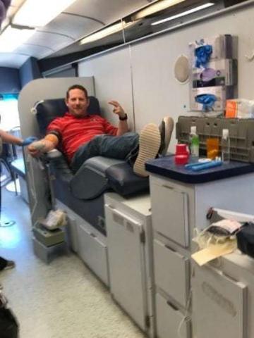Photo of a Decker Electric team member donating blood in the American Red Cross bus