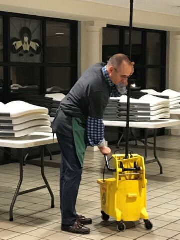 Decker staff member moping the floor at the Lord's Diner in Wichita