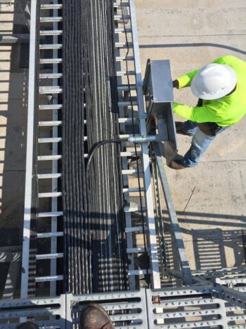 Decker electricians working on wires inside panels