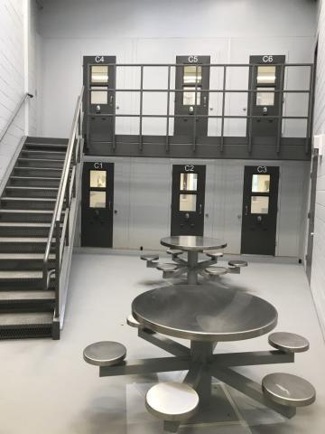 Image inside a jail including the doors of 6 cells and tables, where Decker electricians provided security work for