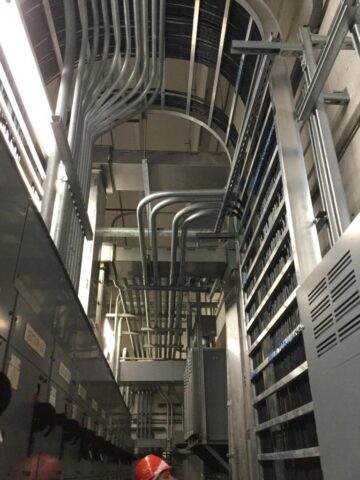 looking up at ceiling filled with many pipes inside a food service building worked on by Decker Electric